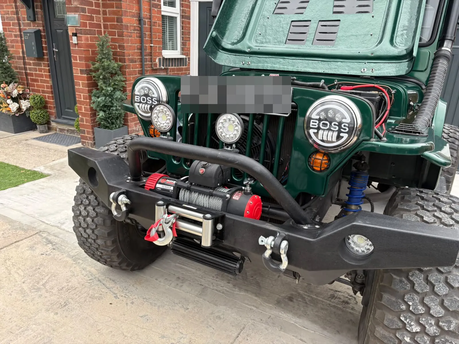 A close look at the front of the finished Jeep: winch, shackles and lit lamps