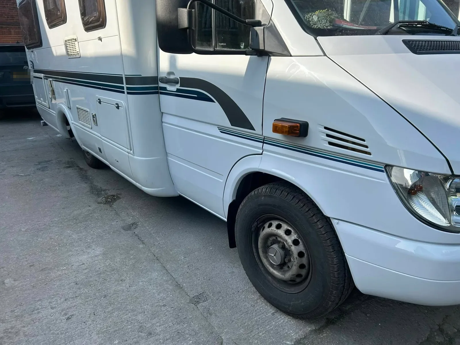 A white Mercedes motorhome at the workshop