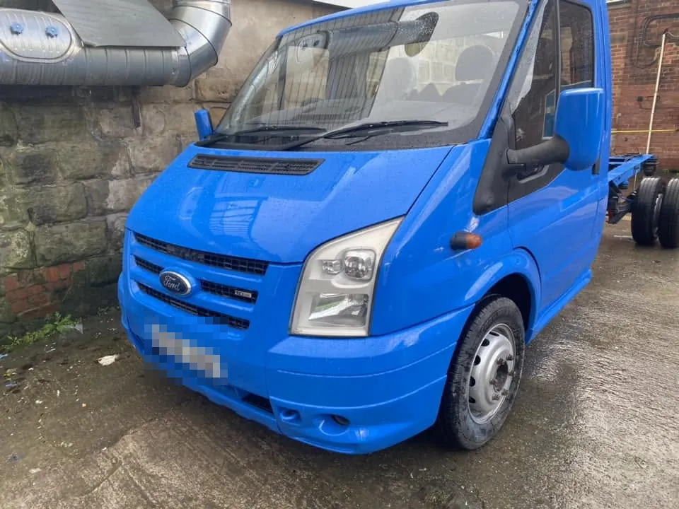 A Ford Transit chassis cab, its cab resprayed bright blue